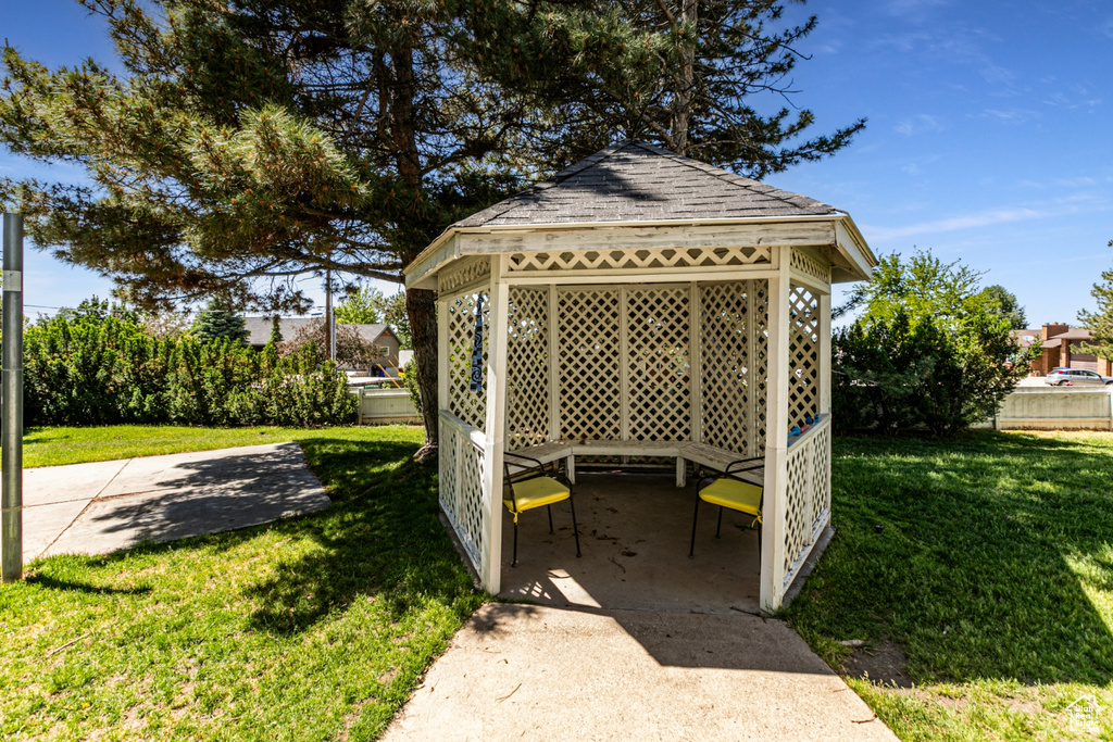 View of grassy yard featuring a gazebo and a patio