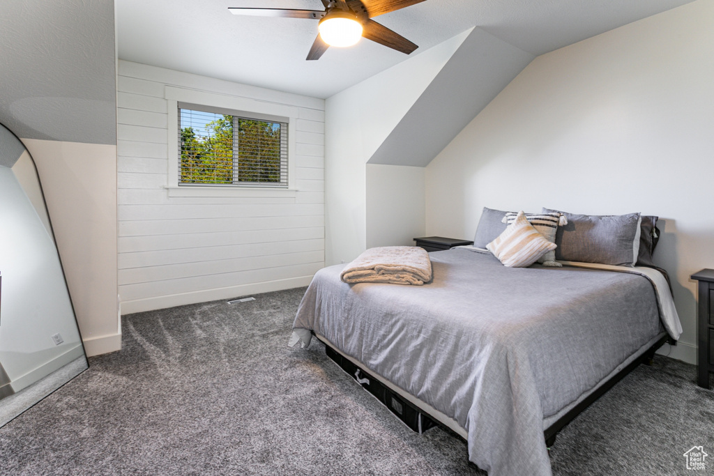 Carpeted bedroom with a ceiling fan
