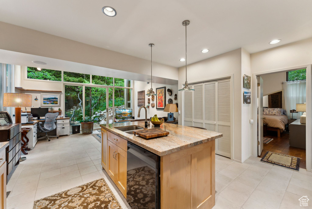 Kitchen featuring a desk, a sink, plenty of natural light, light brown cabinets, and recessed lighting