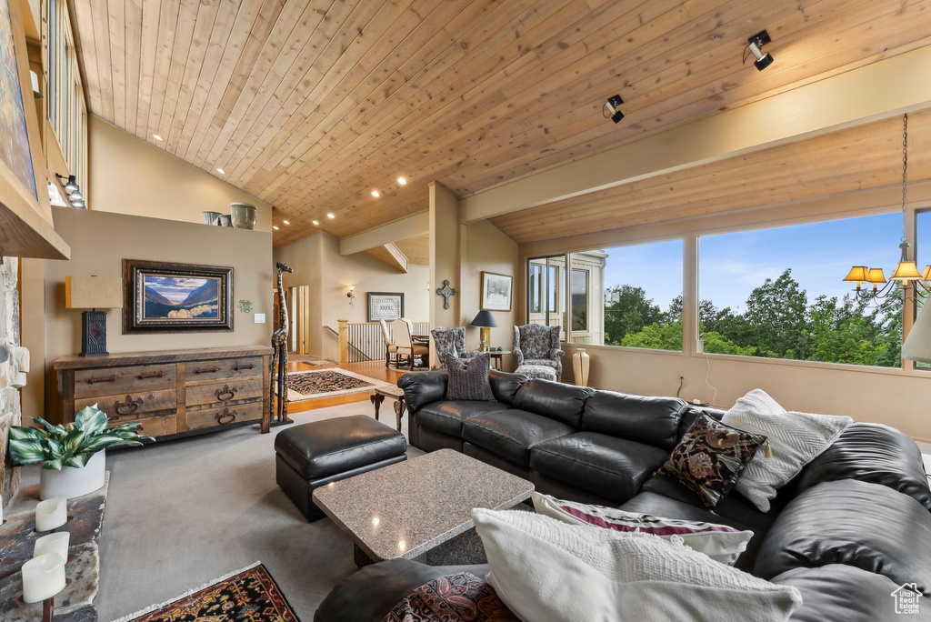 Carpeted living room featuring lofted ceiling and wood ceiling