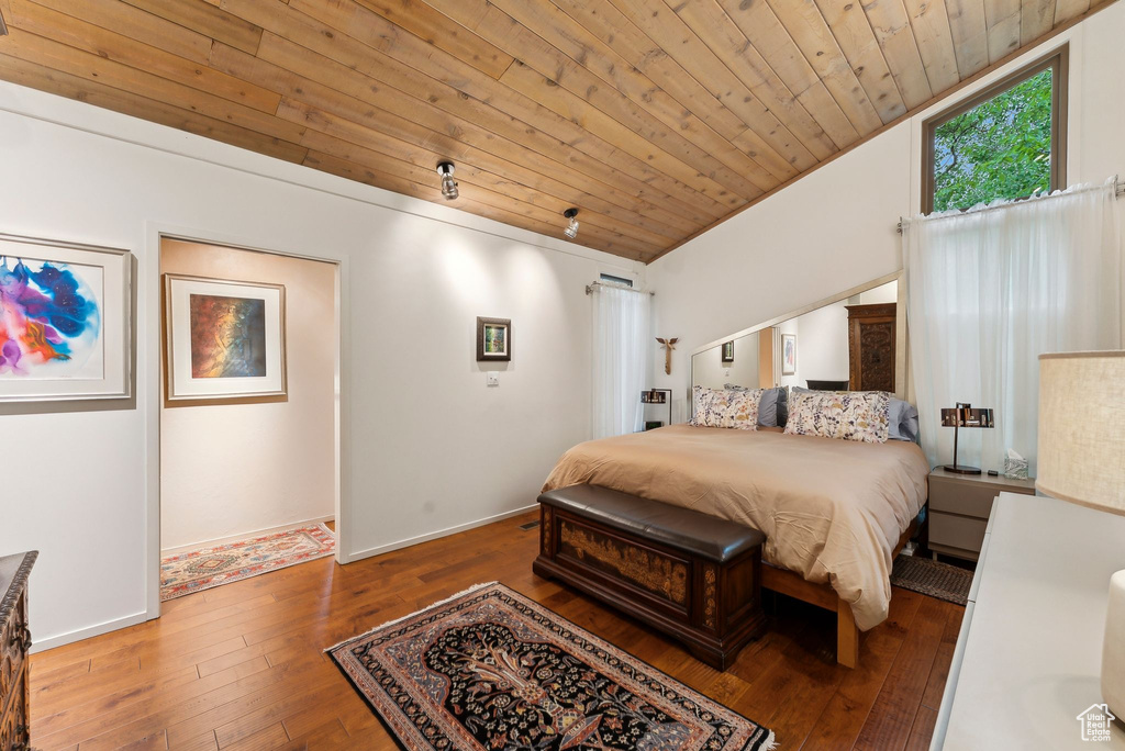 Bedroom with wood ceiling, hardwood / wood-style floors, vaulted ceiling, and baseboards