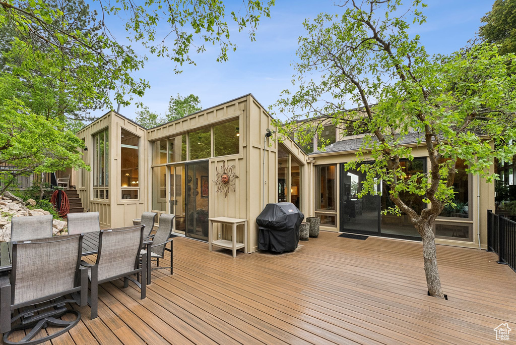 Wooden terrace with grilling area and outdoor dining area