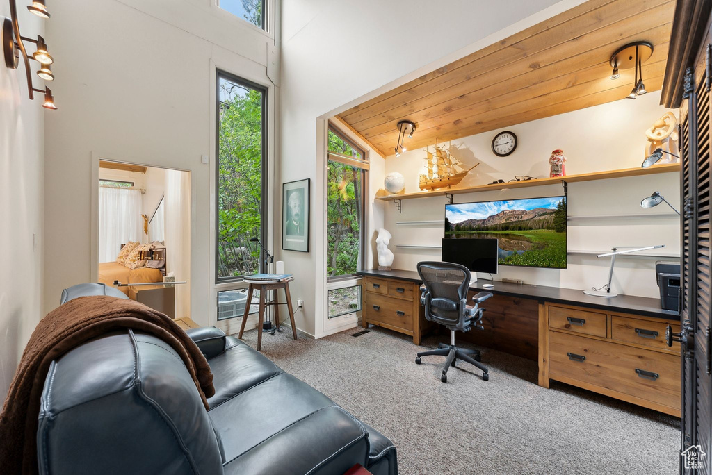 Carpeted office space with built in study area