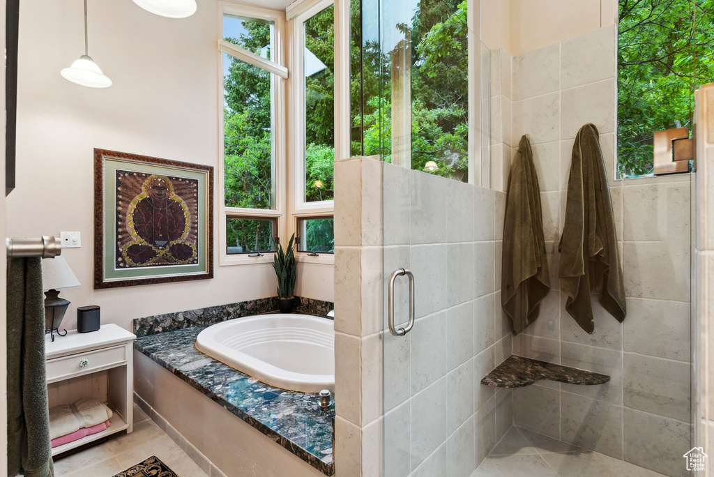 Bathroom featuring a shower stall and a bath