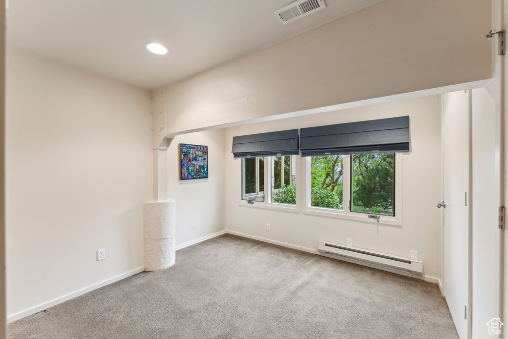 Unfurnished room with a baseboard heating unit, carpet, baseboards, and recessed lighting