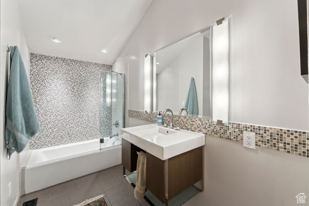 Bathroom with tasteful backsplash, bathtub / shower combination, vanity, tile patterned floors, and recessed lighting