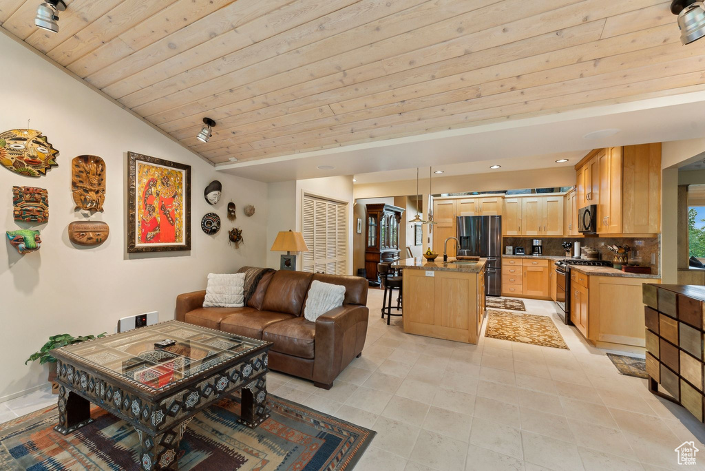 Living room featuring vaulted ceiling, light tile patterned flooring, wood ceiling, and recessed lighting