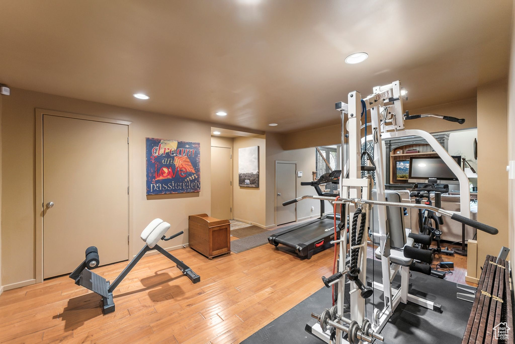 Exercise area with recessed lighting and wood finished floors
