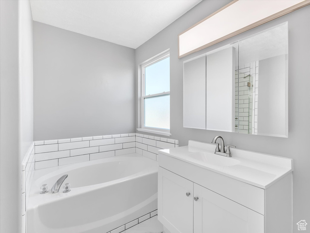 Full bathroom featuring a bath and vanity