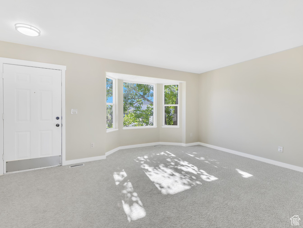 Empty room with baseboards and carpet floors