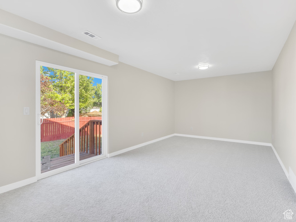 Unfurnished room featuring baseboards and carpet