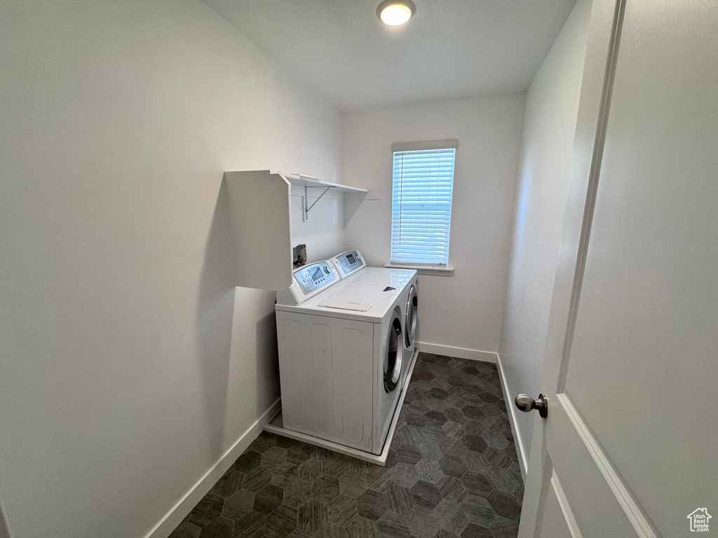 Laundry room featuring washing machine and clothes dryer and baseboards