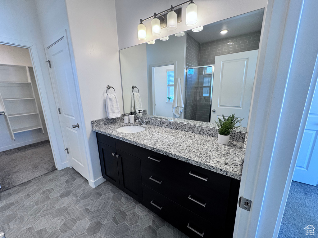 Bathroom with a shower stall and vanity