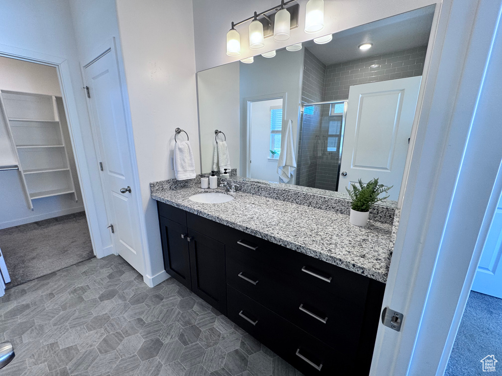 Bathroom featuring a stall shower and vanity