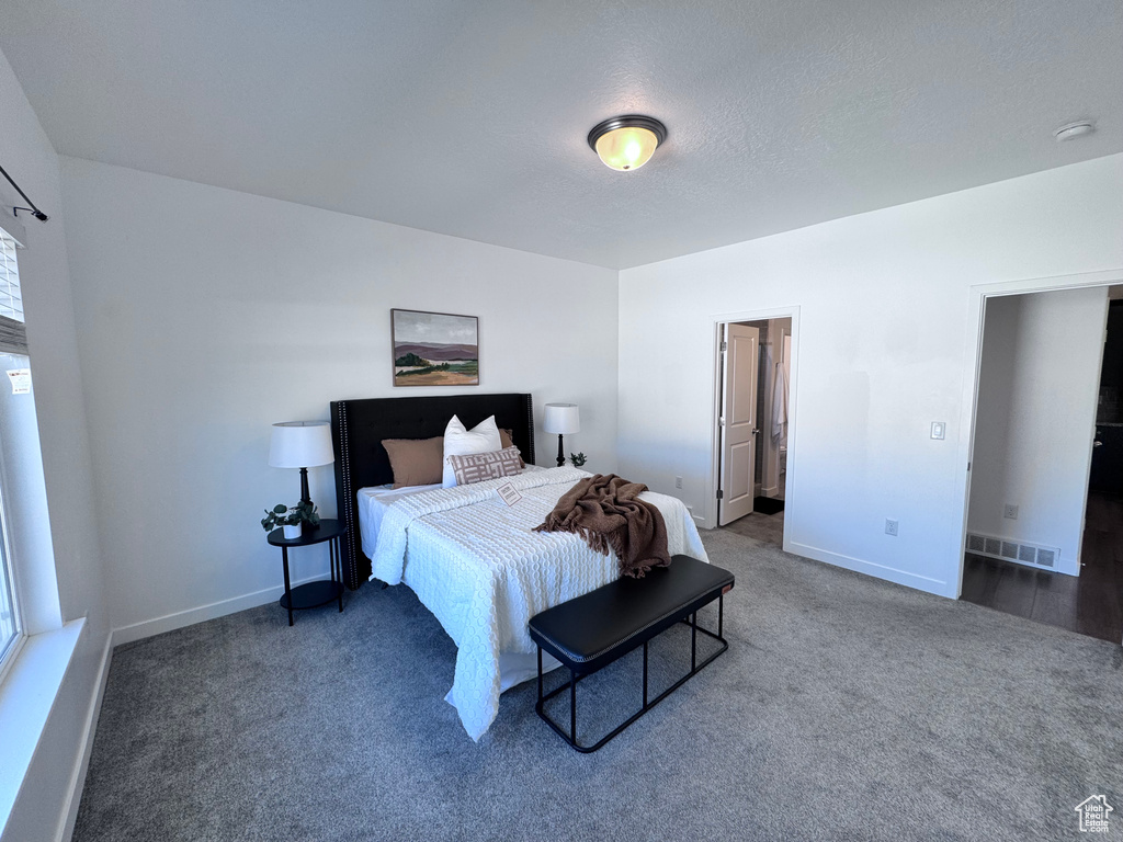 Bedroom with carpet floors and baseboards