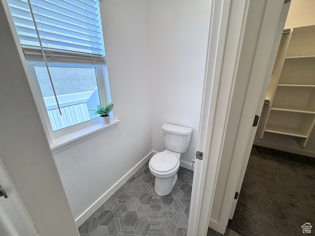 Bathroom featuring toilet and baseboards
