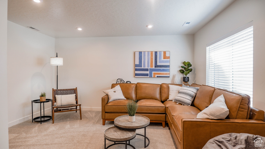 Living area featuring light carpet, recessed lighting, and baseboards
