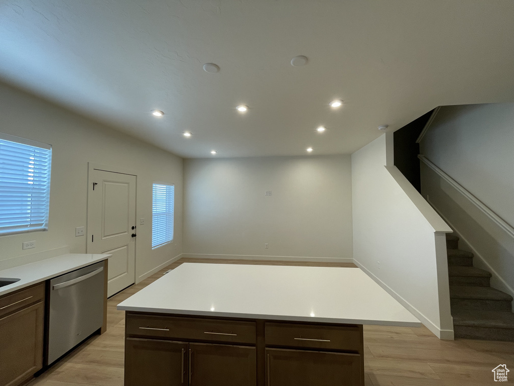 Kitchen with dishwasher, light wood finished floors, recessed lighting, light countertops, and dark brown cabinetry