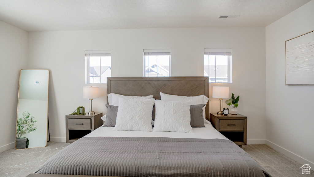 Carpeted bedroom with baseboards