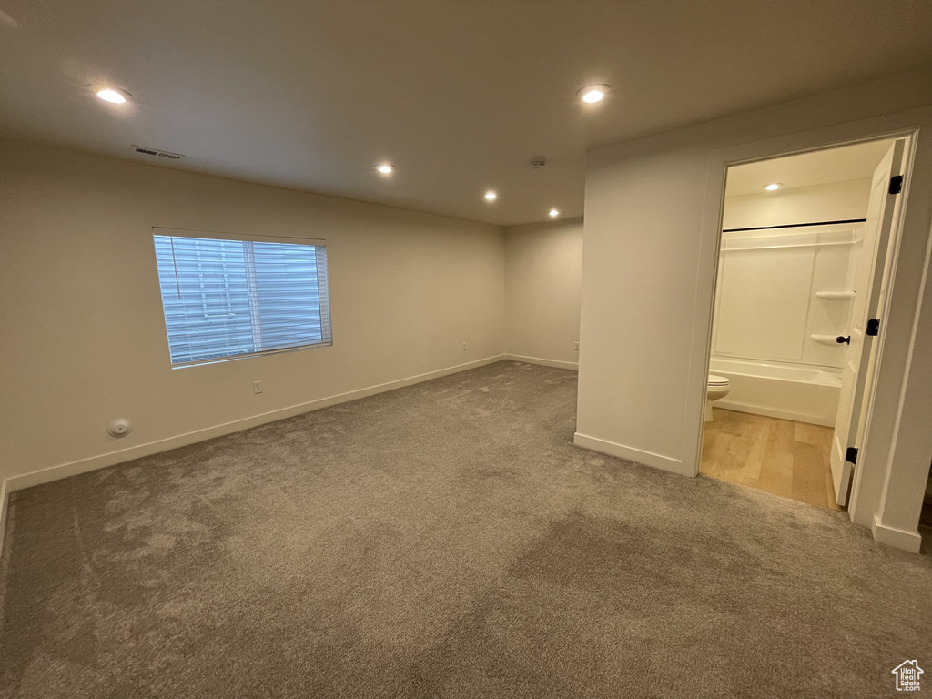 Below grade area with carpet flooring, baseboards, and recessed lighting