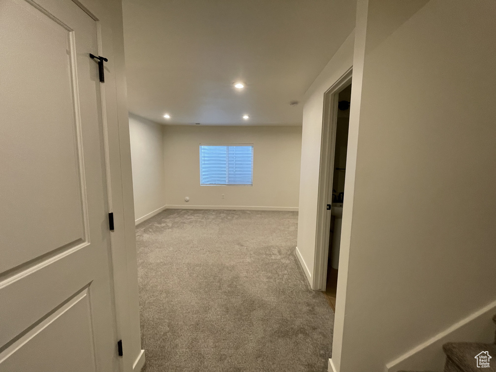 Spare room with carpet floors, recessed lighting, baseboards, and stairs