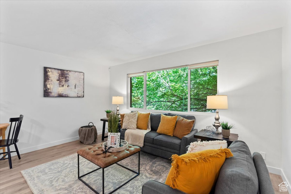 Living area with baseboards and wood finished floors