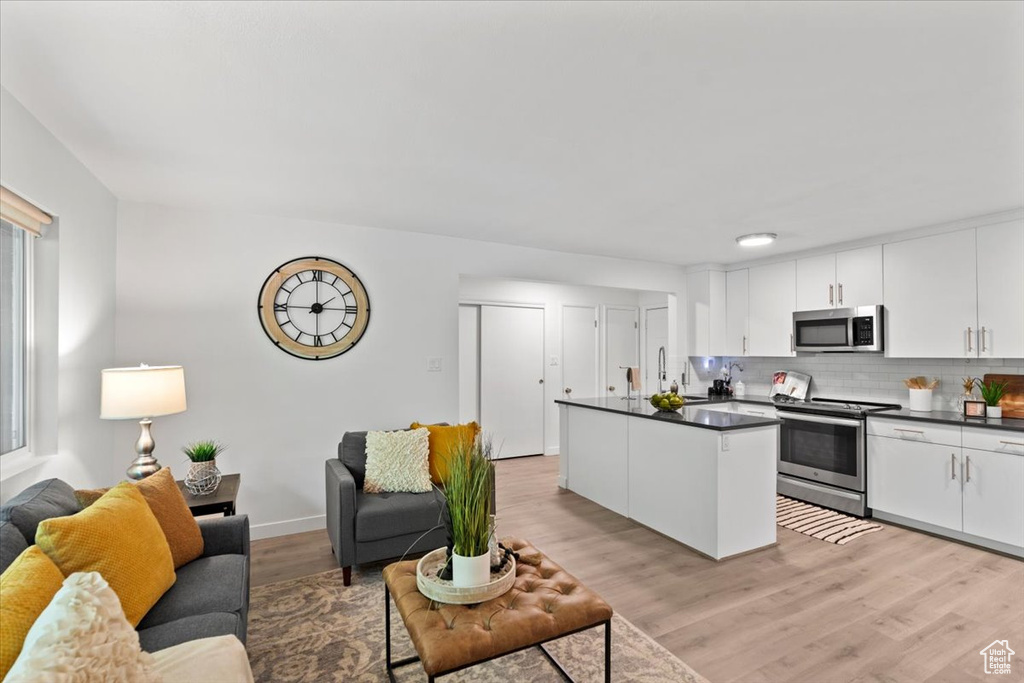 Living area featuring light wood finished floors and baseboards