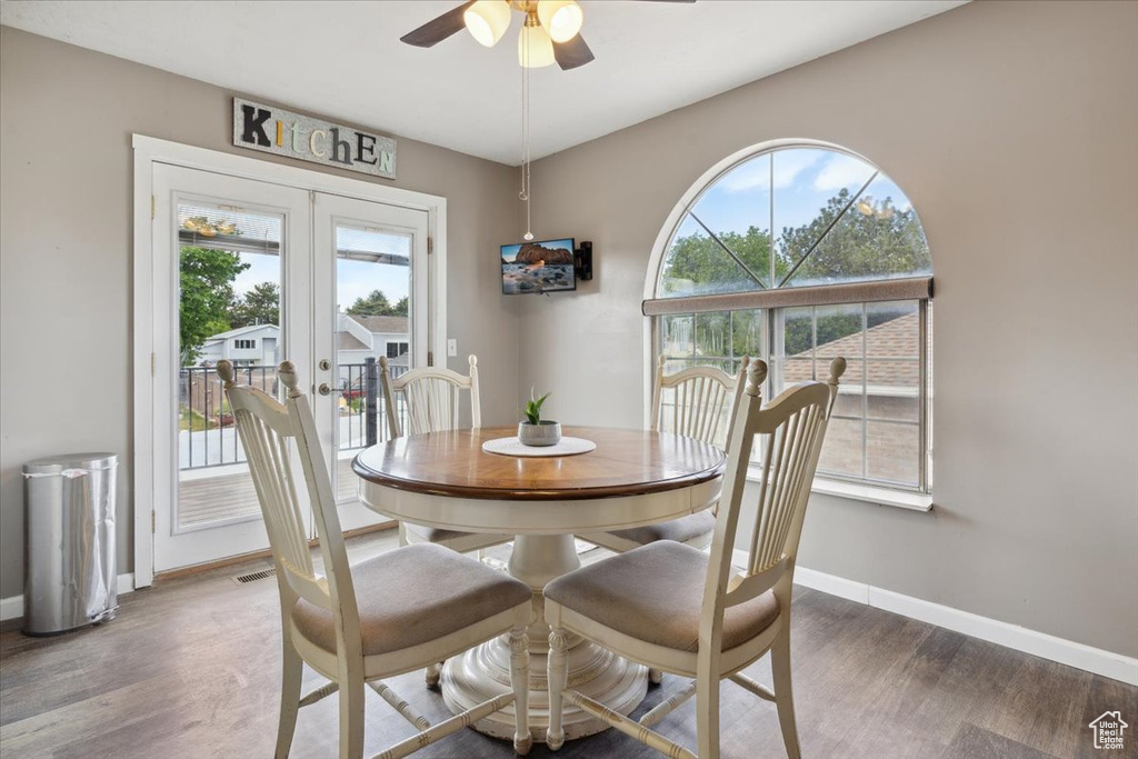 Dining room with ceiling fan, plenty of natural light, and wood finished floors