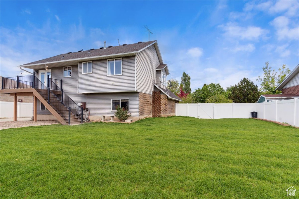 Rear view of property with stairway and a deck