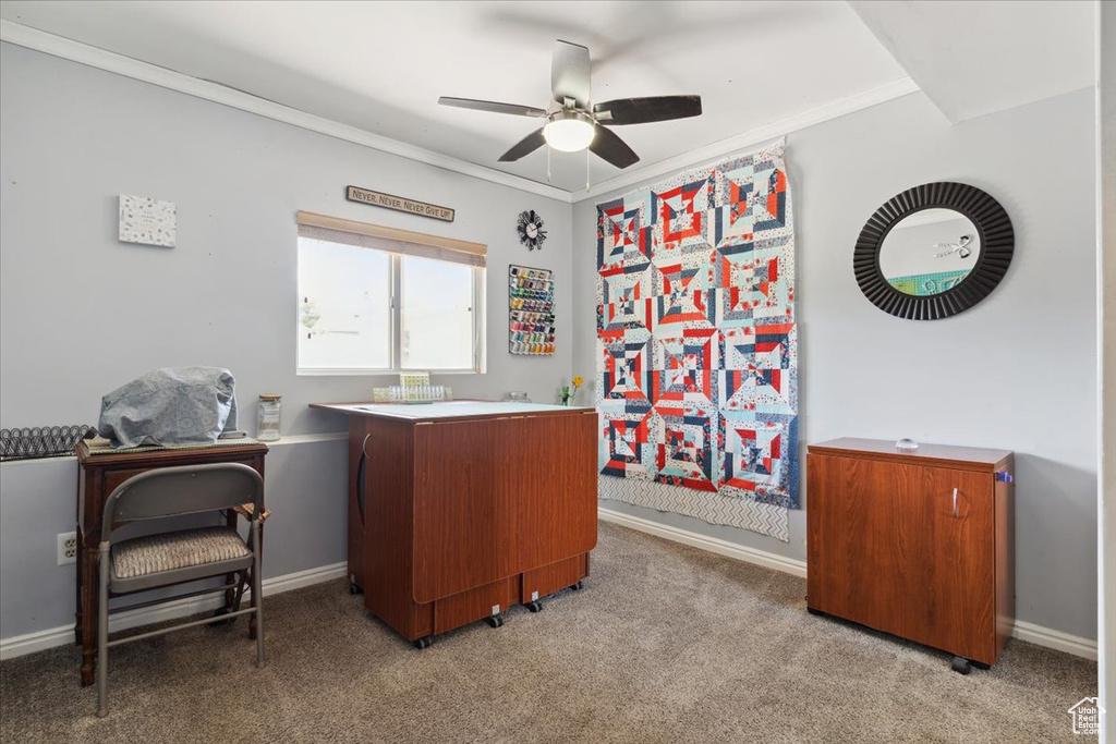 Office space with a ceiling fan, light colored carpet, crown molding, and baseboards