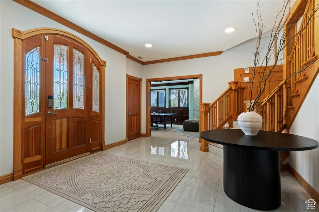 Entrance foyer with stairway, baseboards, ornamental molding, and recessed lighting
