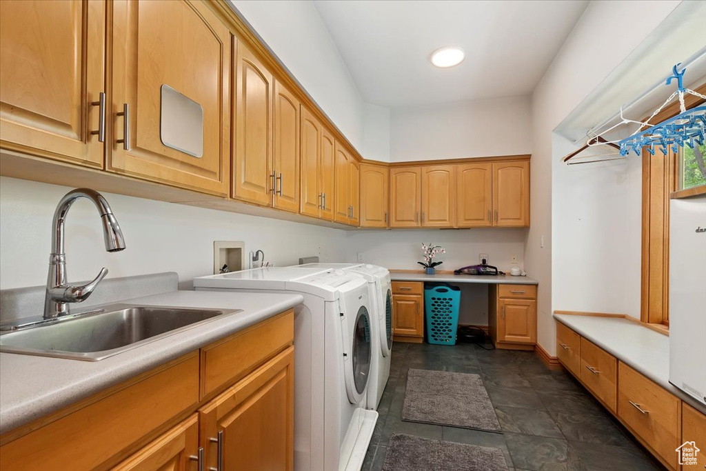 Laundry room featuring cabinet space and separate washer and dryer