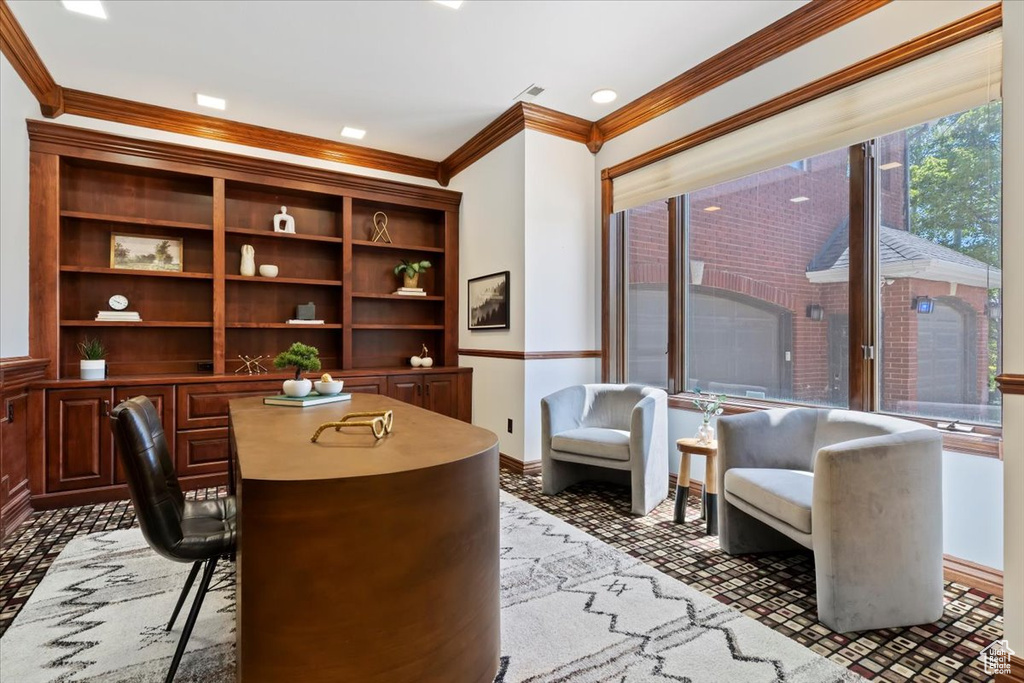Office area with crown molding and baseboards