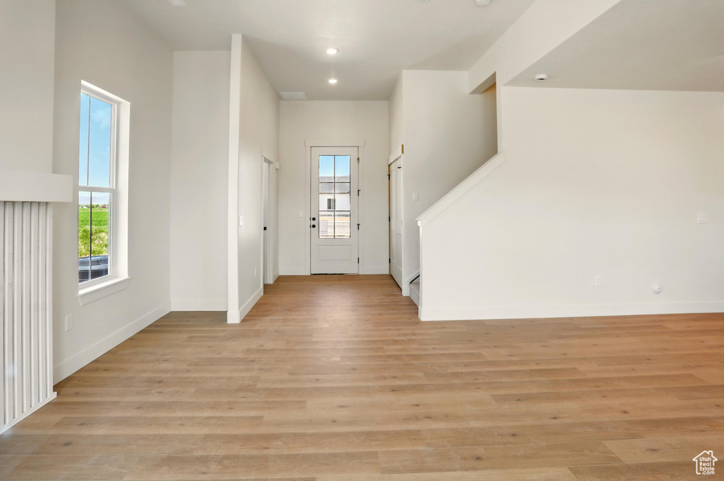 Entrance foyer with stairway, light wood-type flooring, baseboards, and recessed lighting