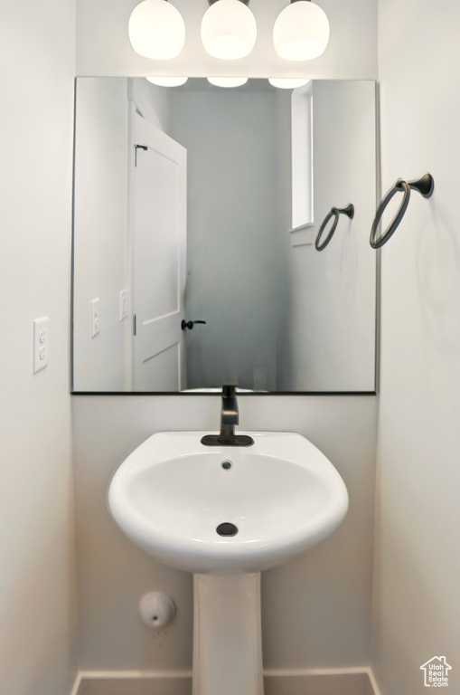 Bathroom featuring a sink and baseboards