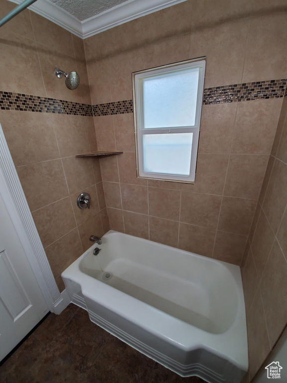 Full bathroom with tub / shower combination and ornamental molding