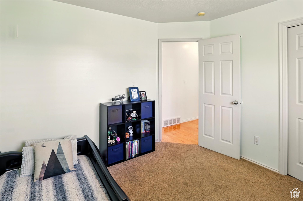 Carpeted bedroom featuring baseboards