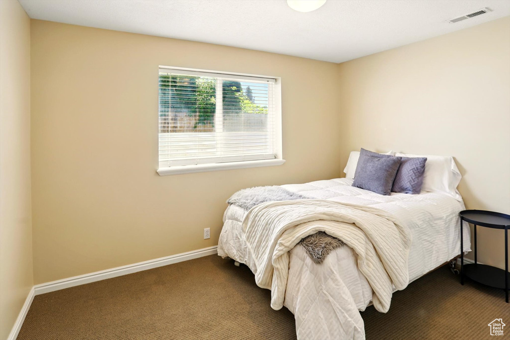 Carpeted bedroom with baseboards