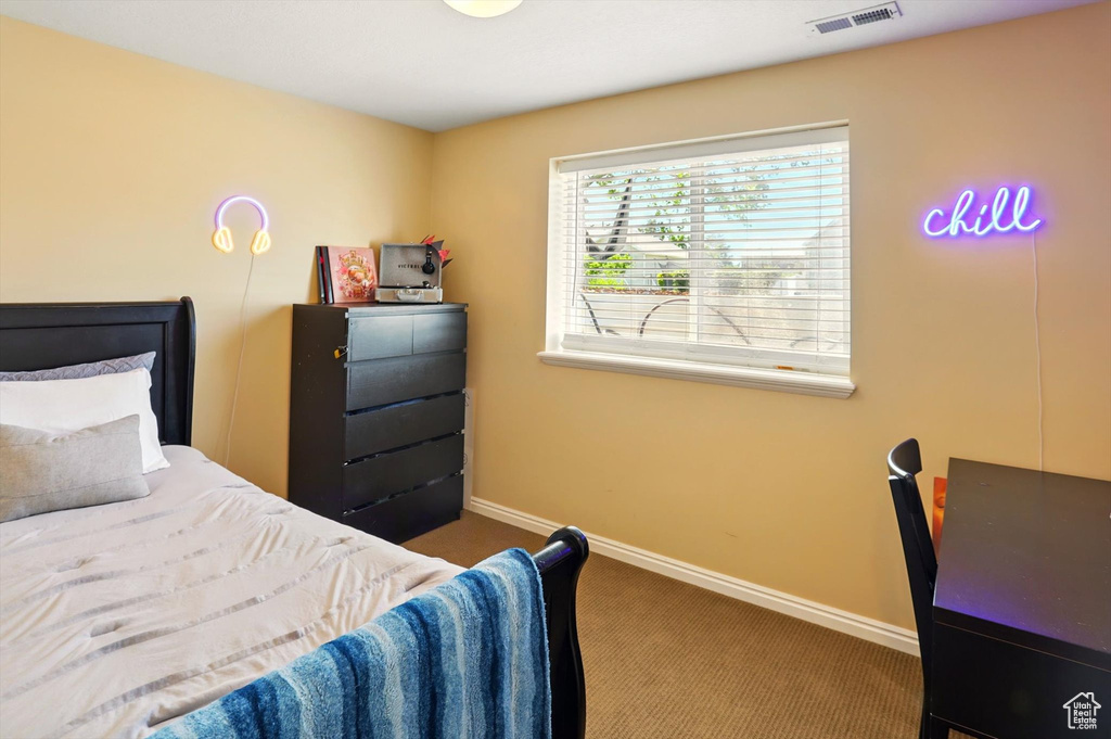 Bedroom featuring carpet flooring and baseboards