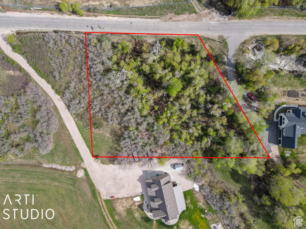 Aerial view of property and surrounding area with property parcel outlined