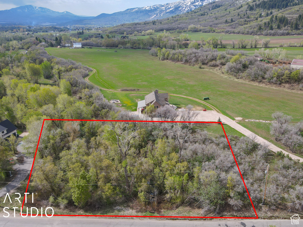 Overview of rural landscape featuring mountains and property parcel outlined