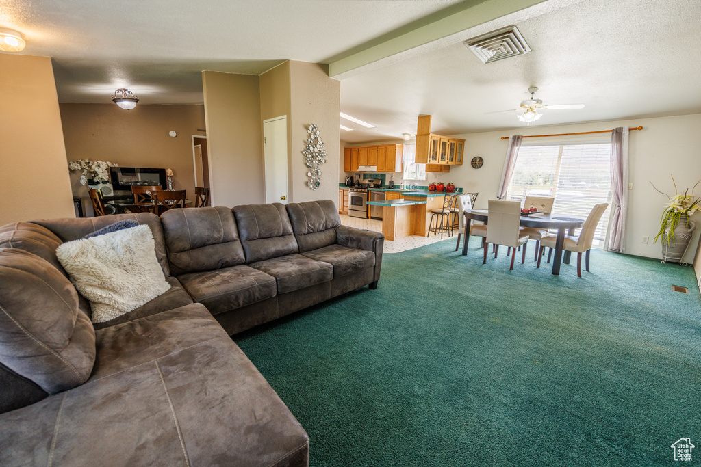 Living area with carpet and a ceiling fan