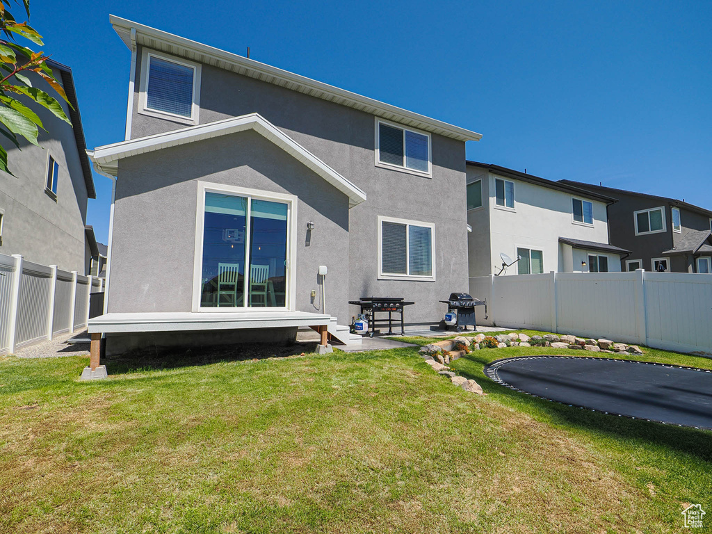 Back of house featuring stucco siding
