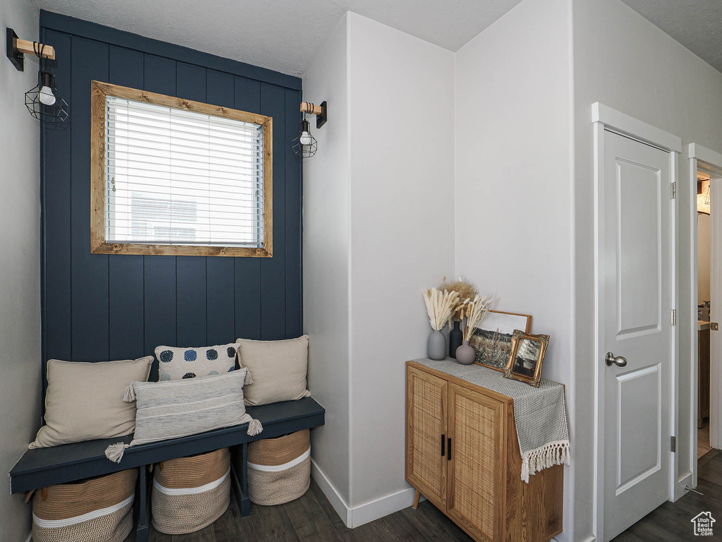 Sitting room with dark wood-style floors and baseboards