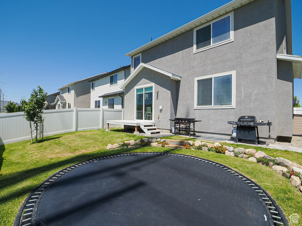 Rear view of house featuring stucco siding and a patio