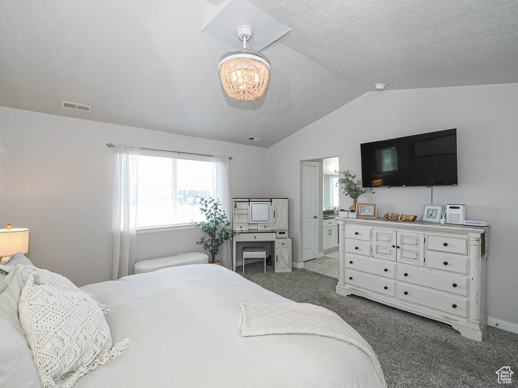 Bedroom featuring lofted ceiling, carpet, a chandelier, baseboards, and ensuite bath