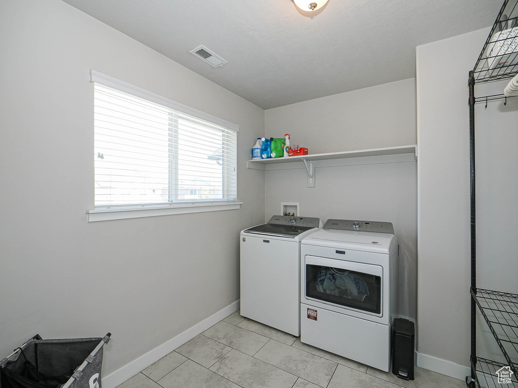 Laundry area featuring washer and clothes dryer and baseboards