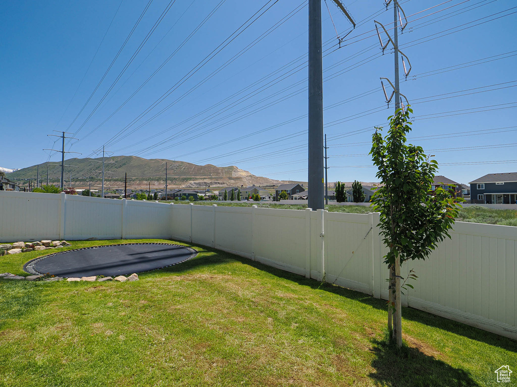 View of yard featuring a mountain view and a trampoline