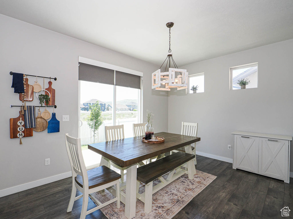 Dining room featuring a chandelier, plenty of natural light, and dark wood-style flooring