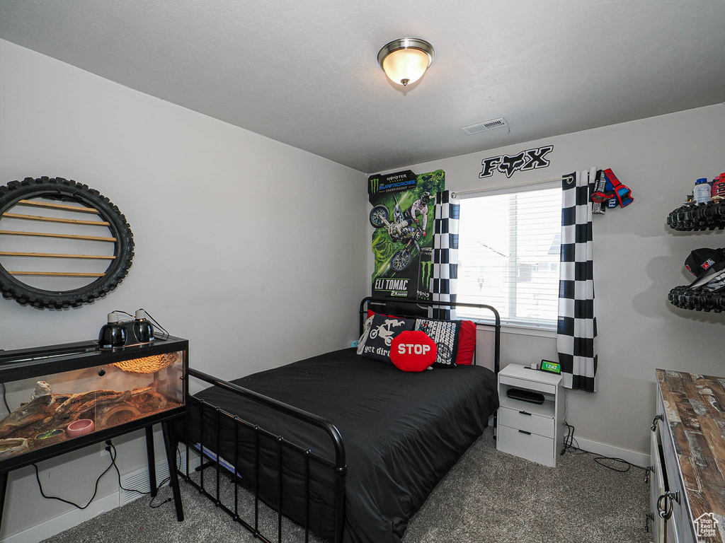 Carpeted bedroom with baseboards